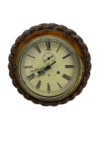 Circular carved oak wall clock with a quartz movement