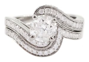Platinum single stone round brilliant cut diamond crossover ring