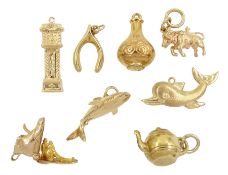 Seven 9ct gold pendant /charms including shark