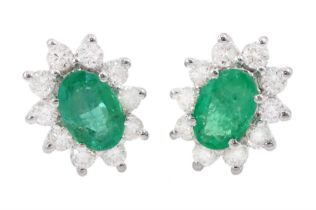 Pair of 18ct white gold oval cut emerald and round brilliant cut diamond cluster stud earrings