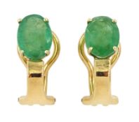 Pair of 18ct gold single stone oval cut emerald clip-on earrings