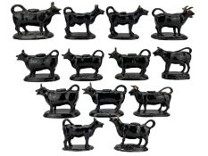 Thirteen 19th century and later Jackfield and other similar cow creamers