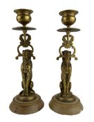 Pair of 19th century bronze candlesticks modelled as a seated lioness holding aloft the sconce in it