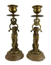 Pair of 19th century bronze candlesticks modelled as a seated lioness holding aloft the sconce in it