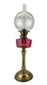 19th/ early 20th century brass oil lamp with cranberry glass reservoir