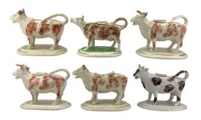 Six Victorian Staffordshire cow creamers with sponged decoration