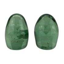 Pair of Victorian green glass sulphide dumpy paperweights each with an inclusion of a pot of flowers