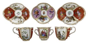Pair of Meissen cabinet cups and saucers of lobed oval design decorated with coastal scenes