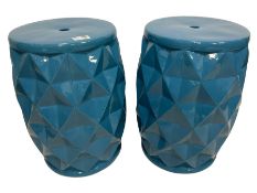 Pair of blue glaze barrel form stands with geometric faceted bodies