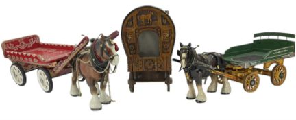 Two pottery cart horses and carts and a traveller's caravan