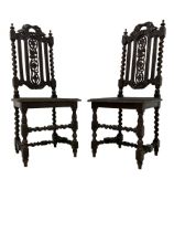 Pair of 19th century Jacobean Revival heavily carved oak hall chairs