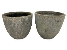 Two cast stone garden planters of rounded tapering form