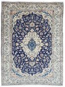 Persian ivory and indigo ground Kashan rug