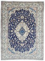 Persian ivory and indigo ground Kashan rug