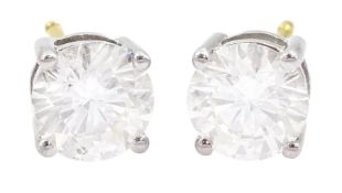 Pair of 18ct white and yellow gold round brilliant cut diamond stud earrings