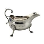 18th century Irish silver cream jug with crimped rim and C scroll leaf capped handle and hoof feet w