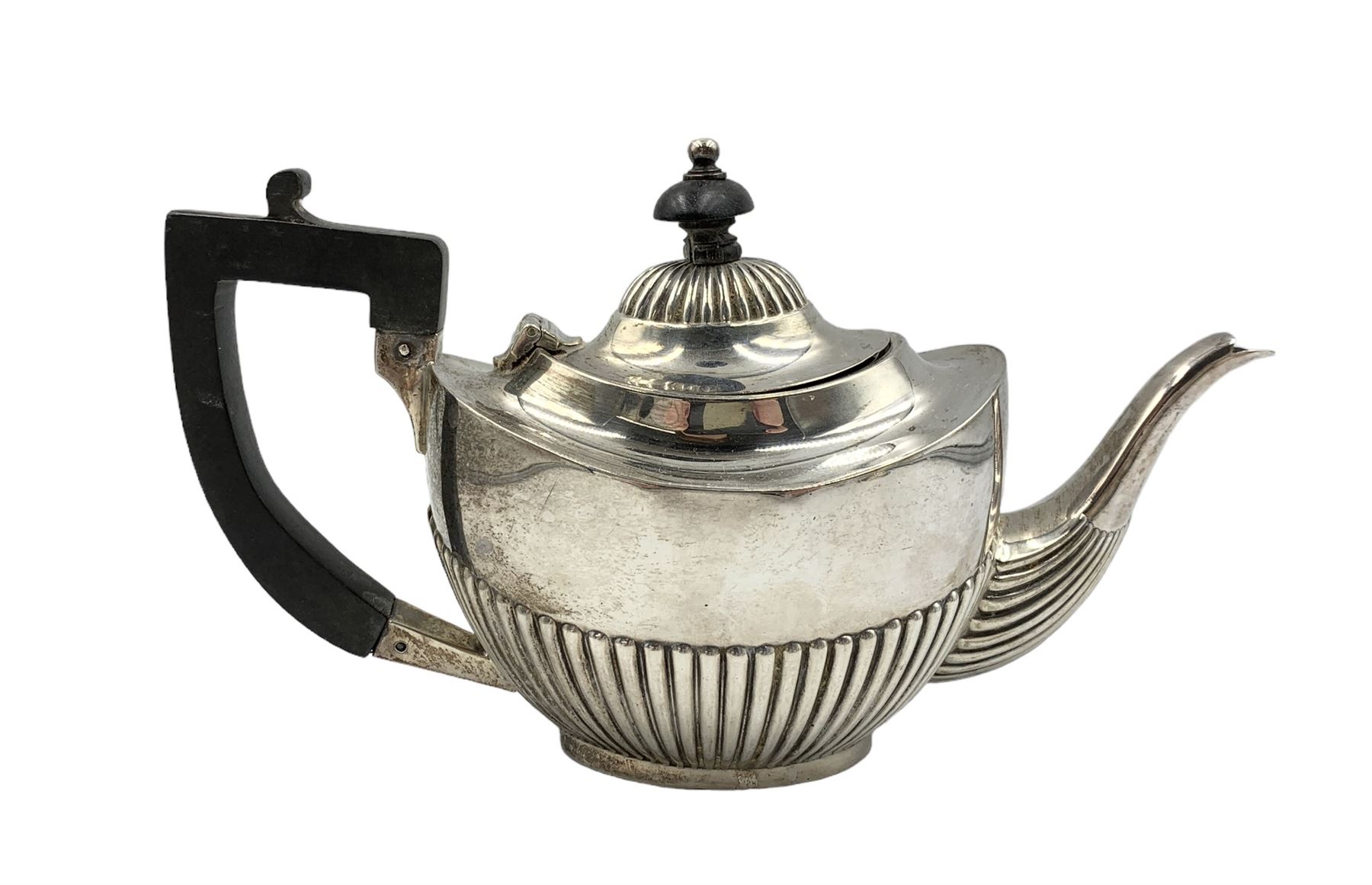 Edwardian silver bachelors teapot of oval form with half body decoration