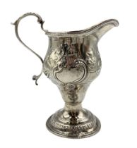 George III silver baluster cream jug with scroll handle and later embossed decoration