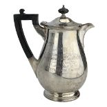 Silver hot water jug of baluster form with ebonised handle and lift