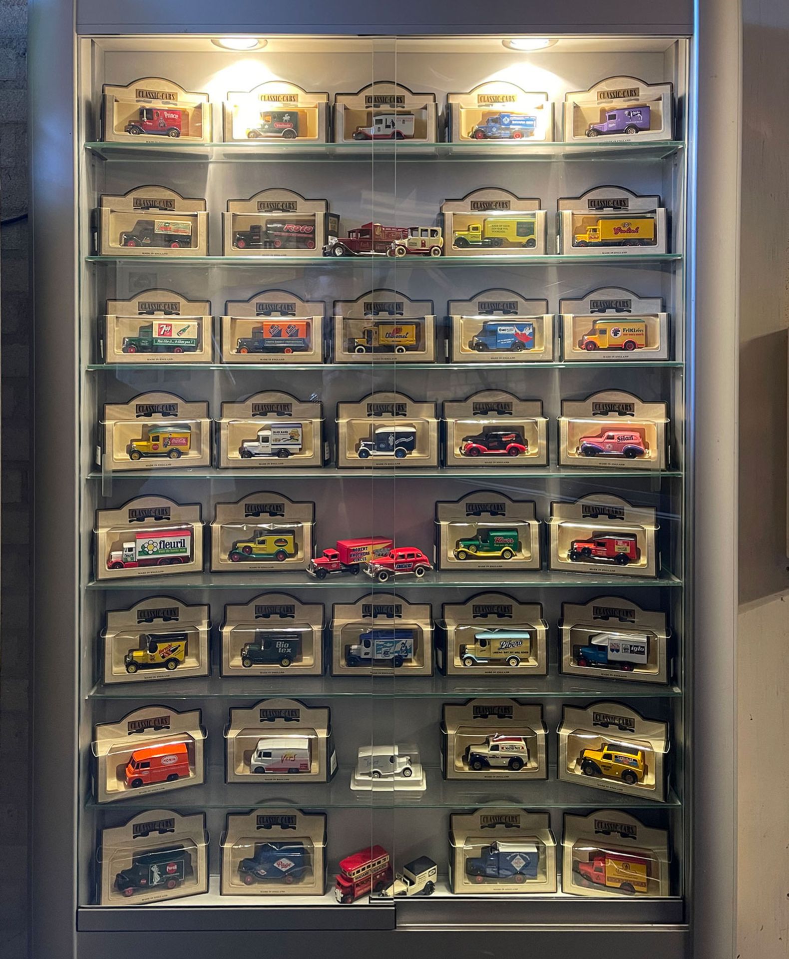 Showcase with 42 various miniature cars