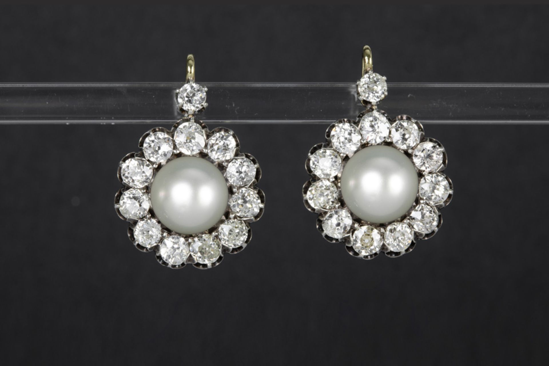 nice pair of 'antique' earrings in silver and yellow gold (18 carat) each with a white pearl