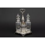 19th century Dutch cruetset in Pieter Pieterse marked silver with its four flasks in crystal and