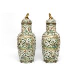 pair of quite big 19th Cent. Chinese lidded vases in porcelain with a Cantonese decor were damaged