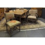set of an antique oak Renaissance revival table with finely sculpted feet and 14 chairs with
