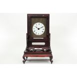 antique Chinese clock with its case (on its stand) in rose-wood and with a round face with Chinese