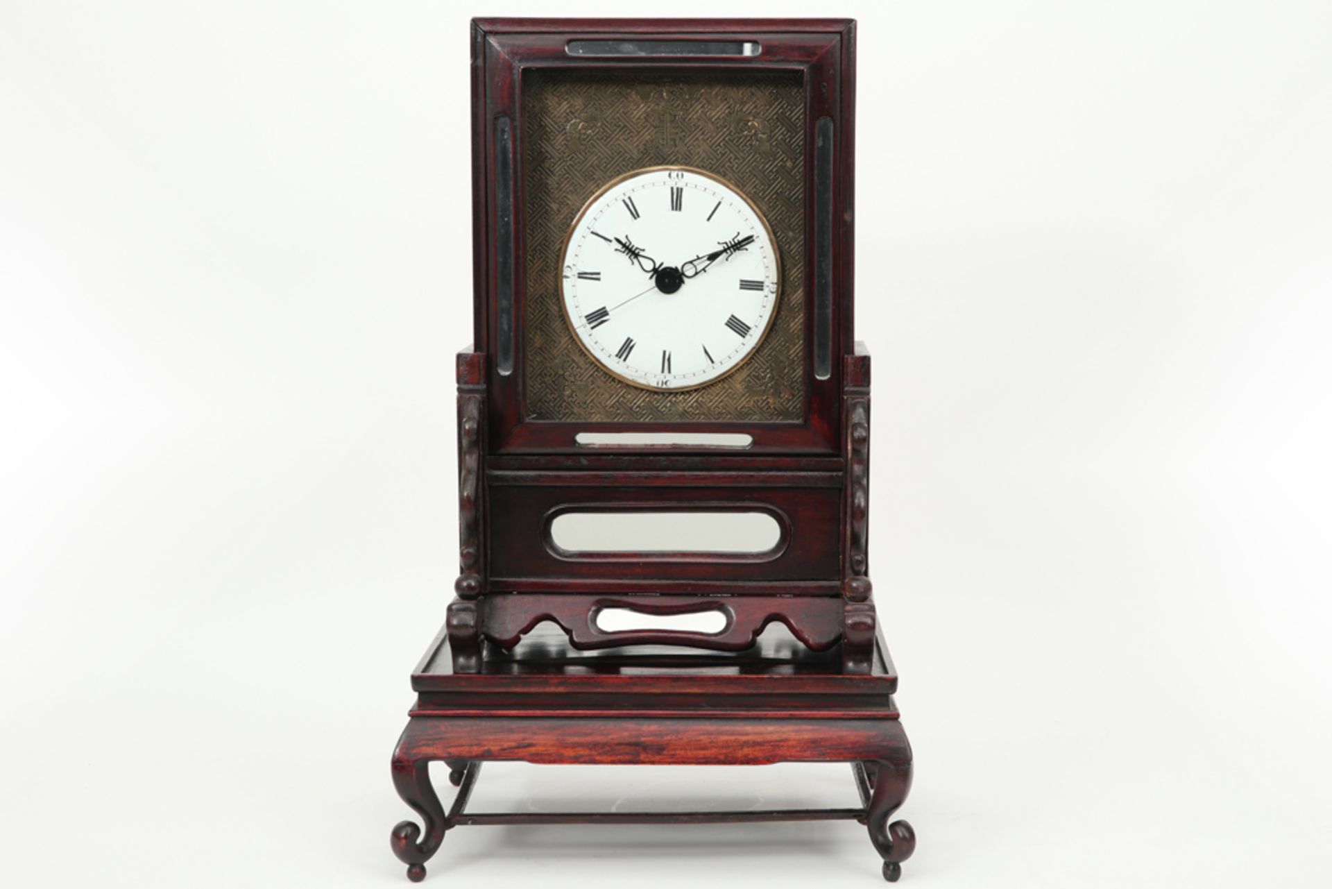 antique Chinese clock with its case (on its stand) in rose-wood and with a round face with Chinese