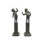 pair of antique garden sculptures in bronze with green patina each with a child, standing on a