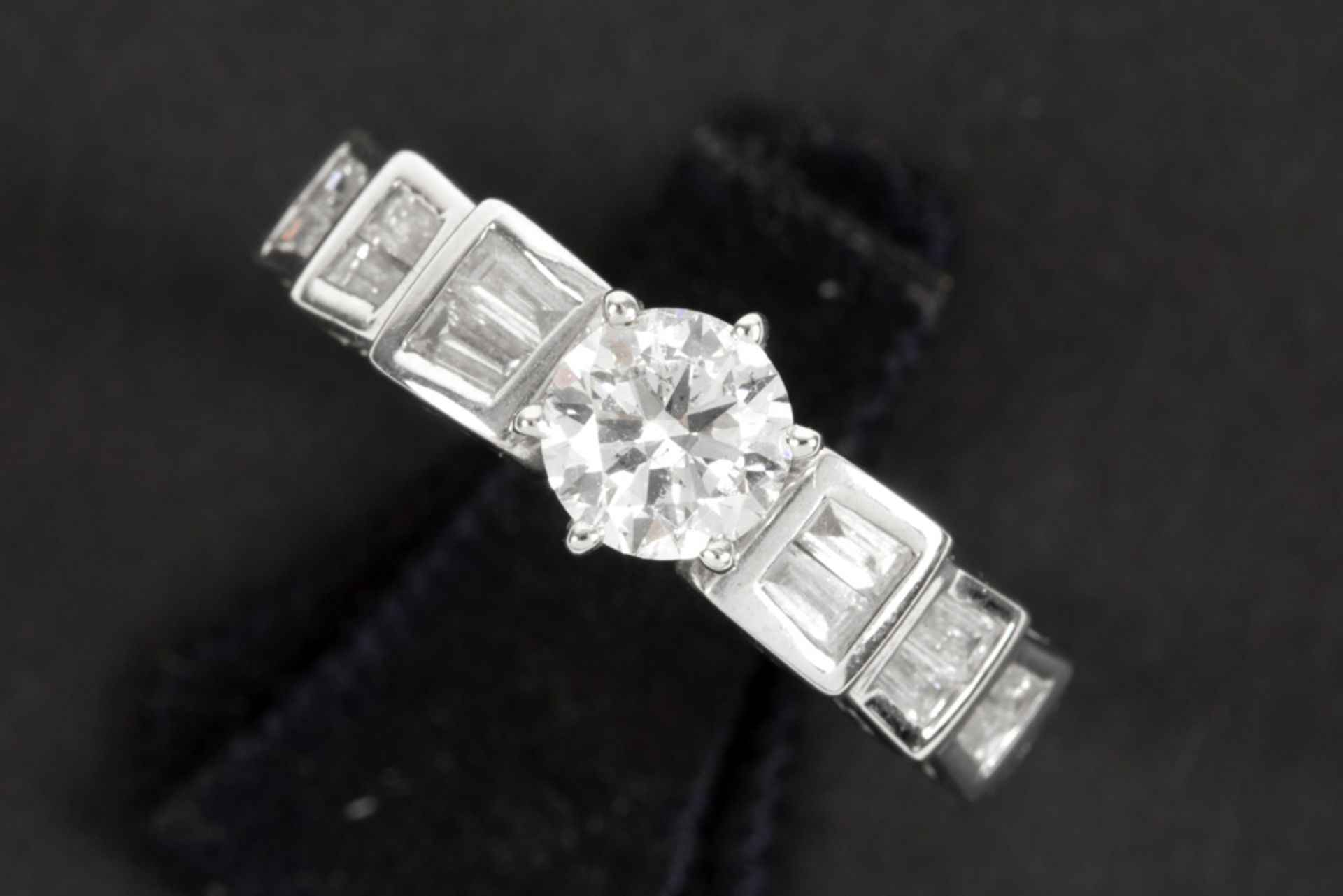 a 0,72 carat brilliant cut diamond set in a ring in white gold (18 carat) with more then 0,40