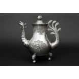 antique Chinese coffeepot in marked silver with handle in the shape of a peacock's tail and the