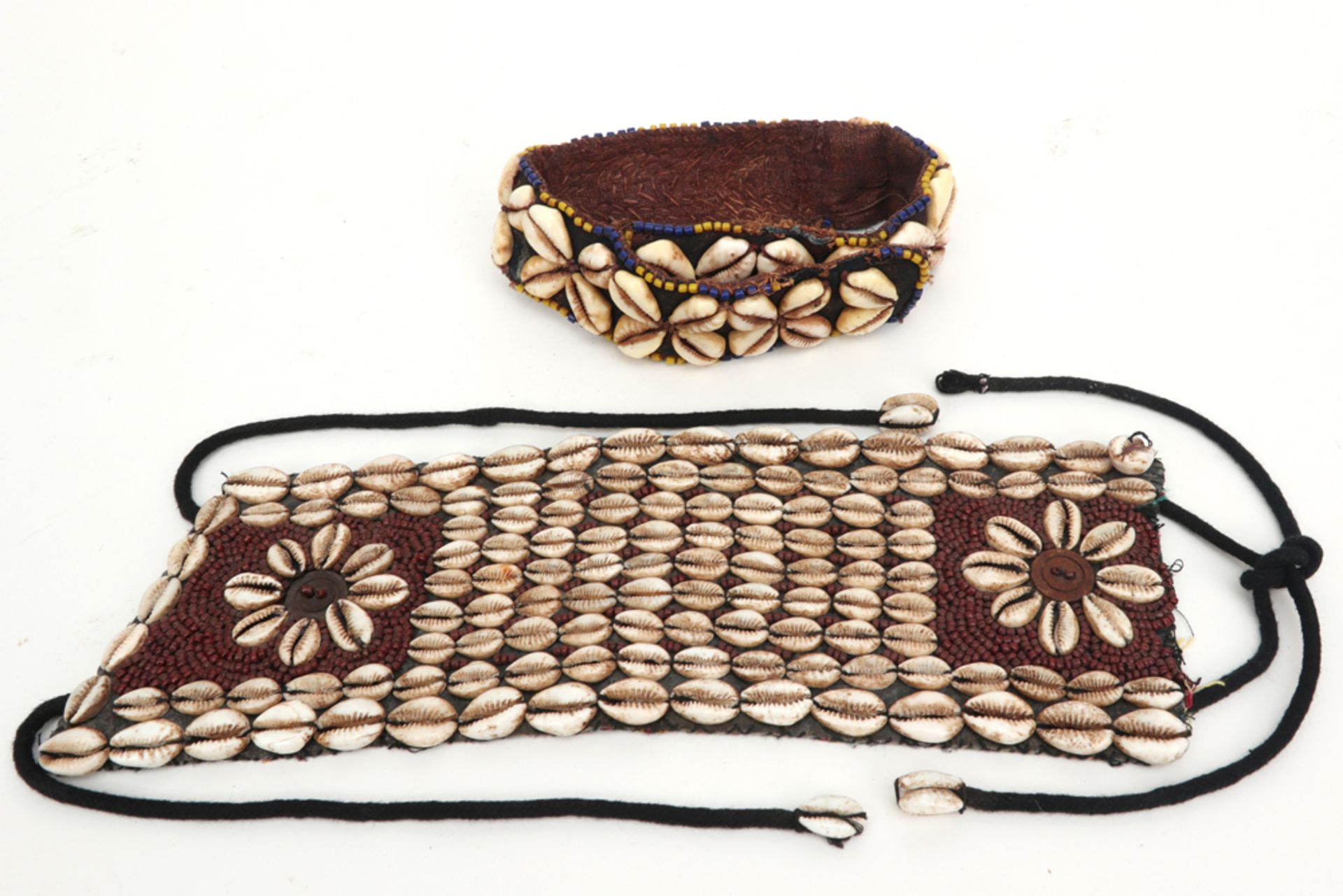 two African Yoruba textile costume band with shells and beads || Lot van twee Afrikaanse Yoruba -