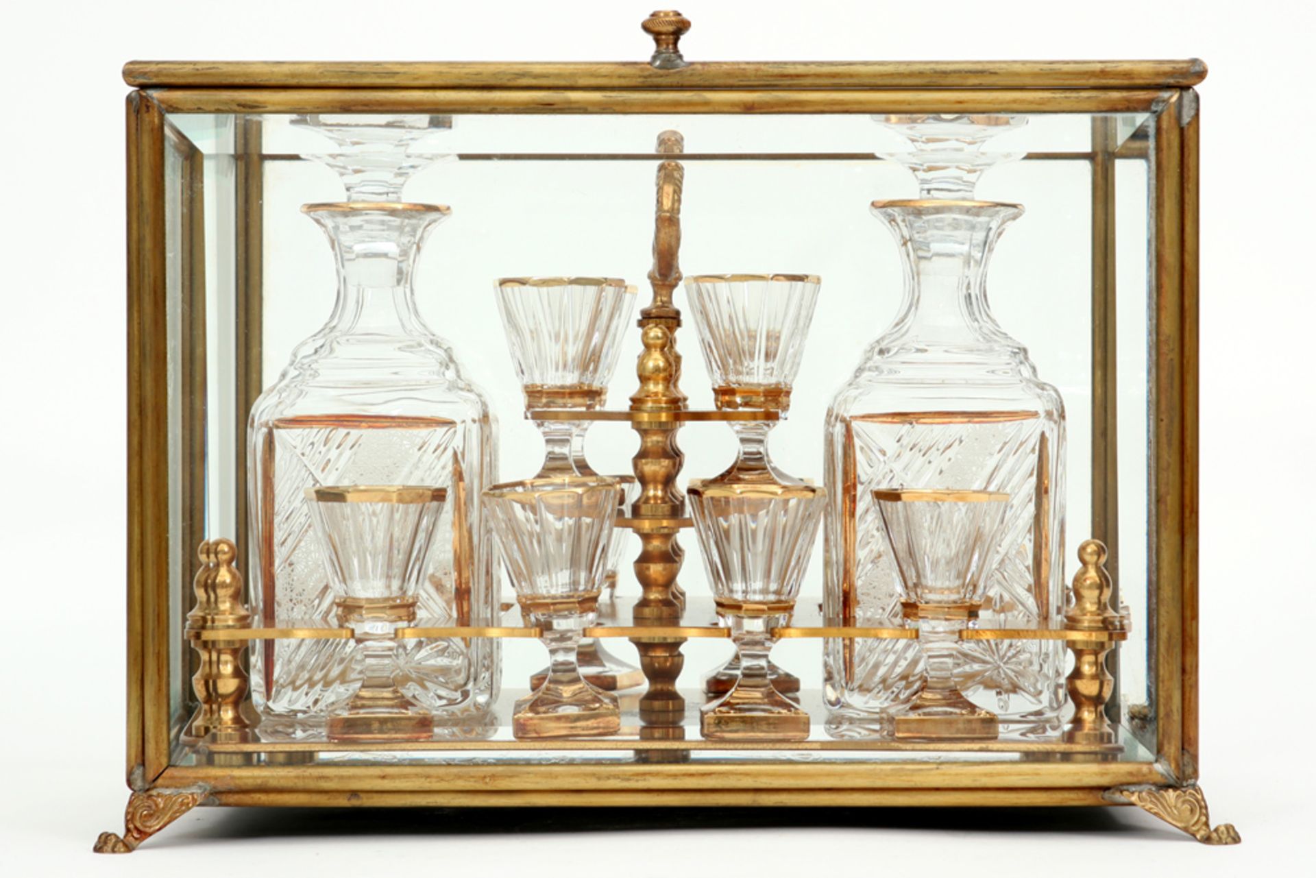 19th Cent. licquor cabinet with case in glass and brass and with its original content of glasses and
