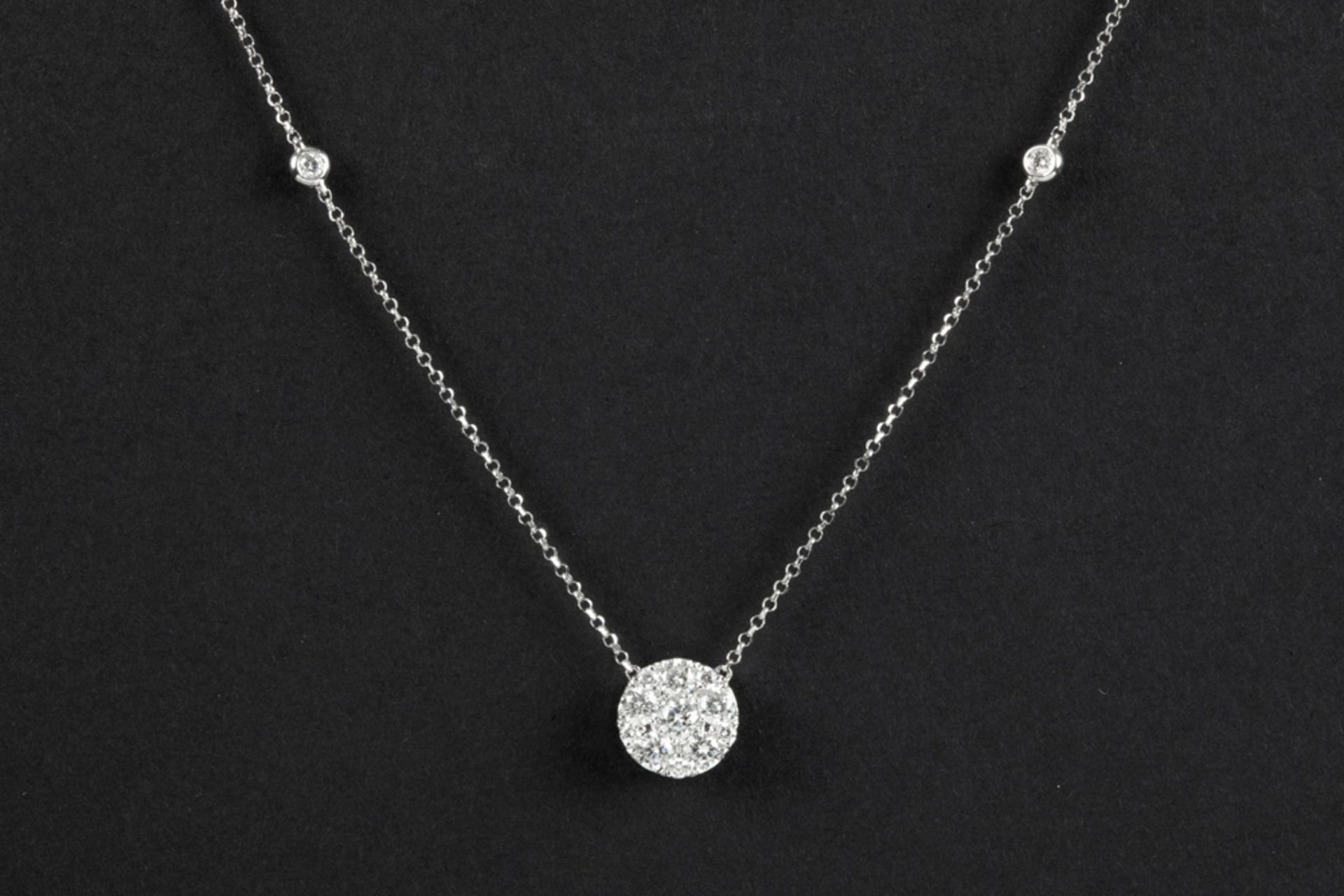 round pendant in white gold (18 carat) with ca 0,50 carat of high quality brilliant cut diamonds -