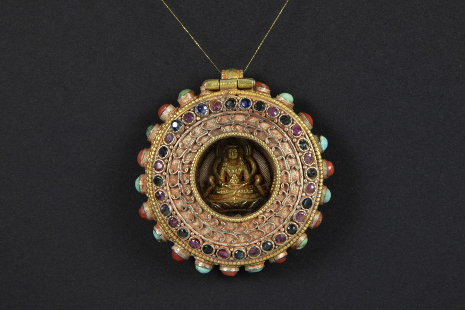 round Tibetan ghau in silver and gold with precious stones (sapphire and ruby), turquoise and