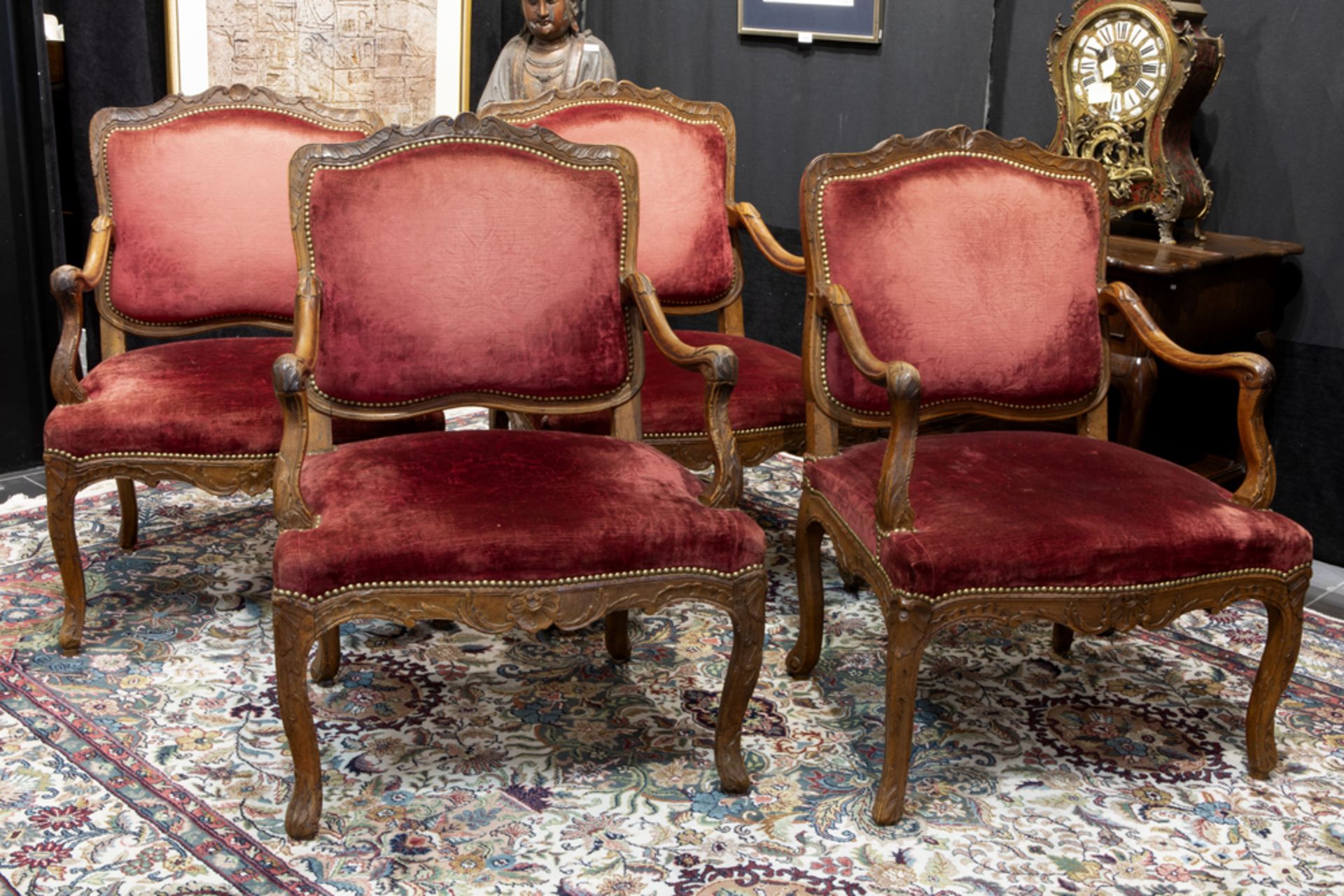 set of four 18th Cent. armchairs in walnut with finely carved Régence style ornamentation||Set van