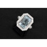 ring in white gold (18 carat) with a 6,24 carat blue radiant cut topaz surrounded by circa 1 carat