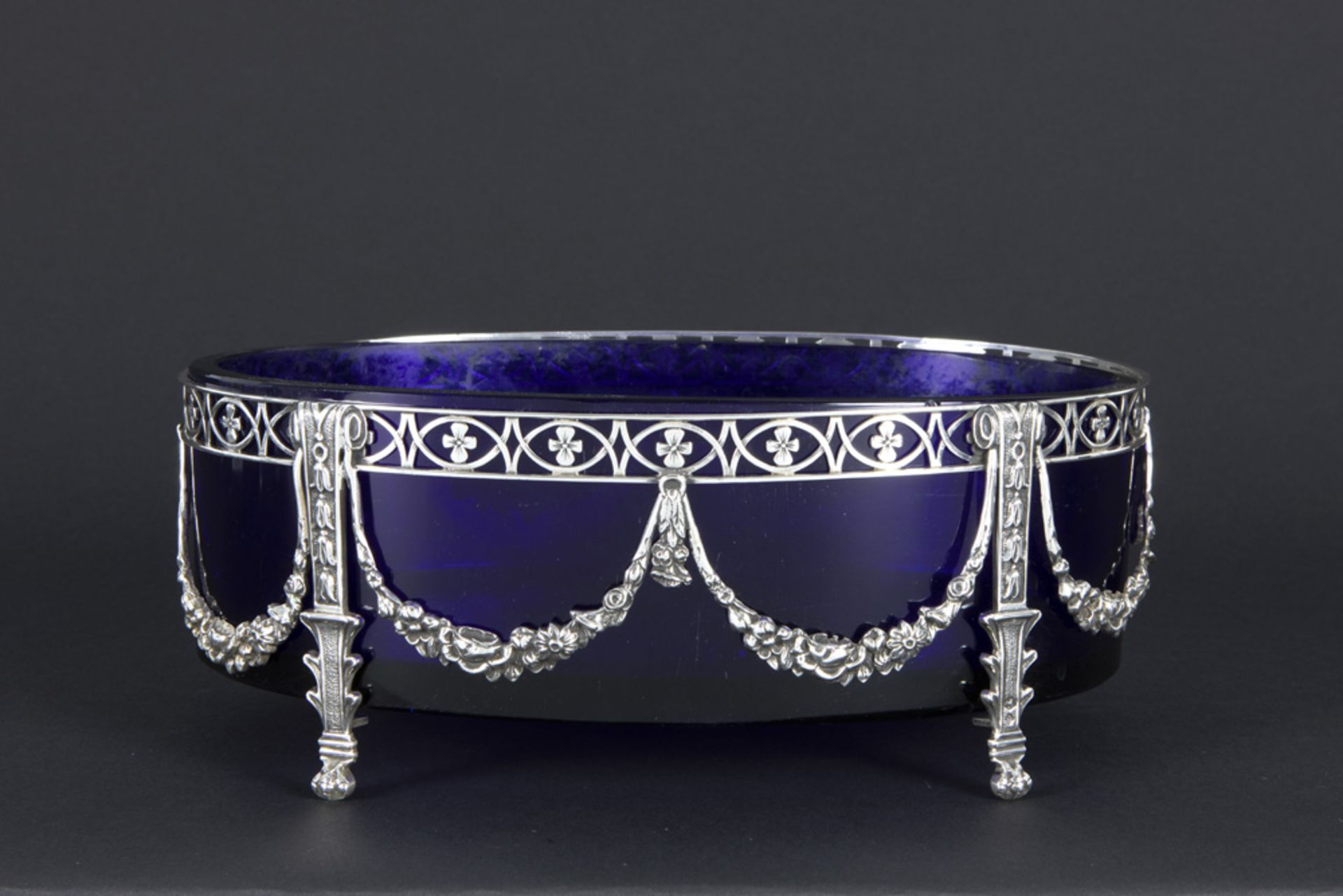 Dutch neoclassical oval centerpiece in blue glass with a mounting in marked silver||ZAANLANDSE