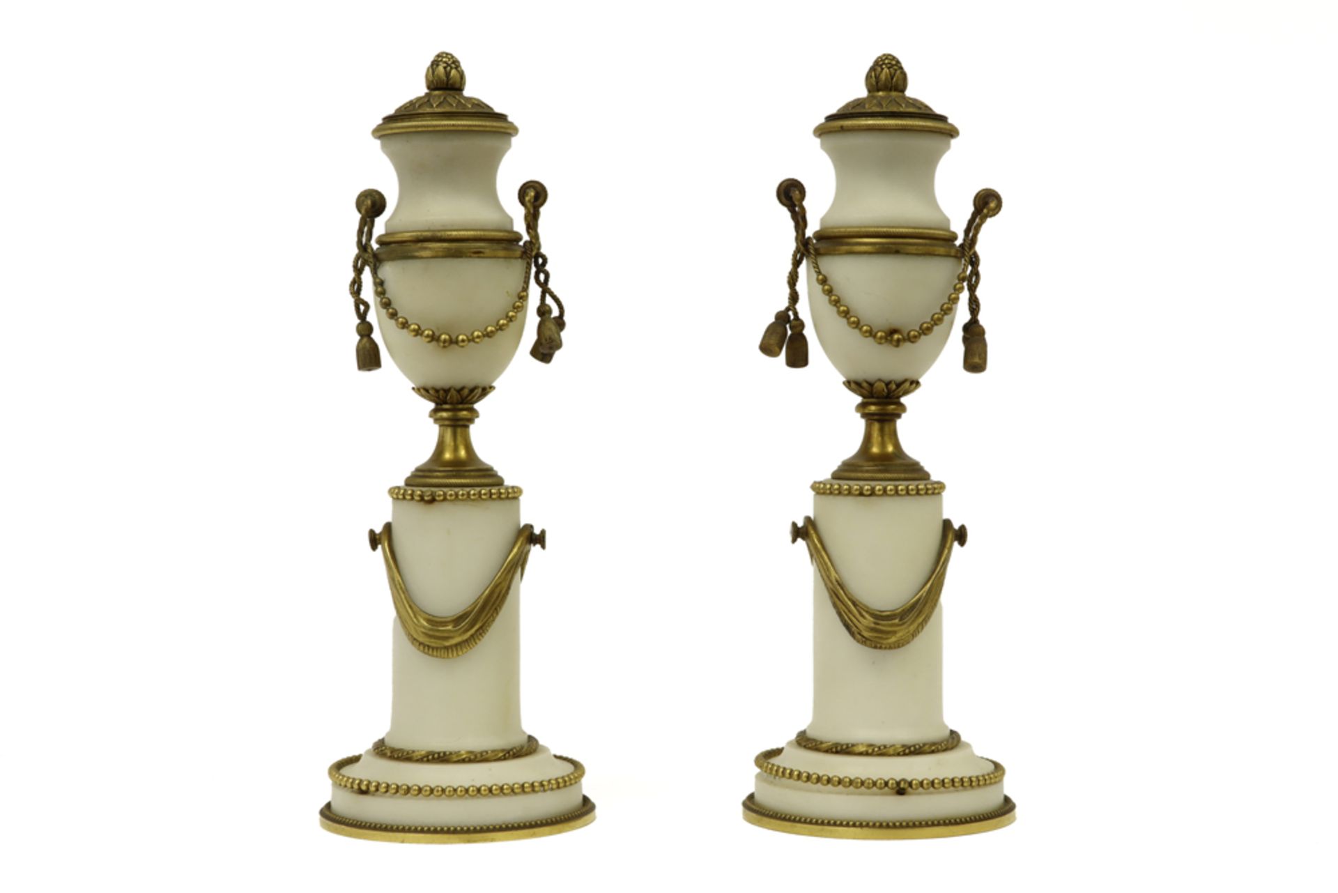 pair of late 18th Cent. Louis XVI style lidded vases on pillar in white marble and gilded bronze||