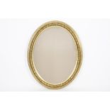 oval mirror with an antique gilded frame