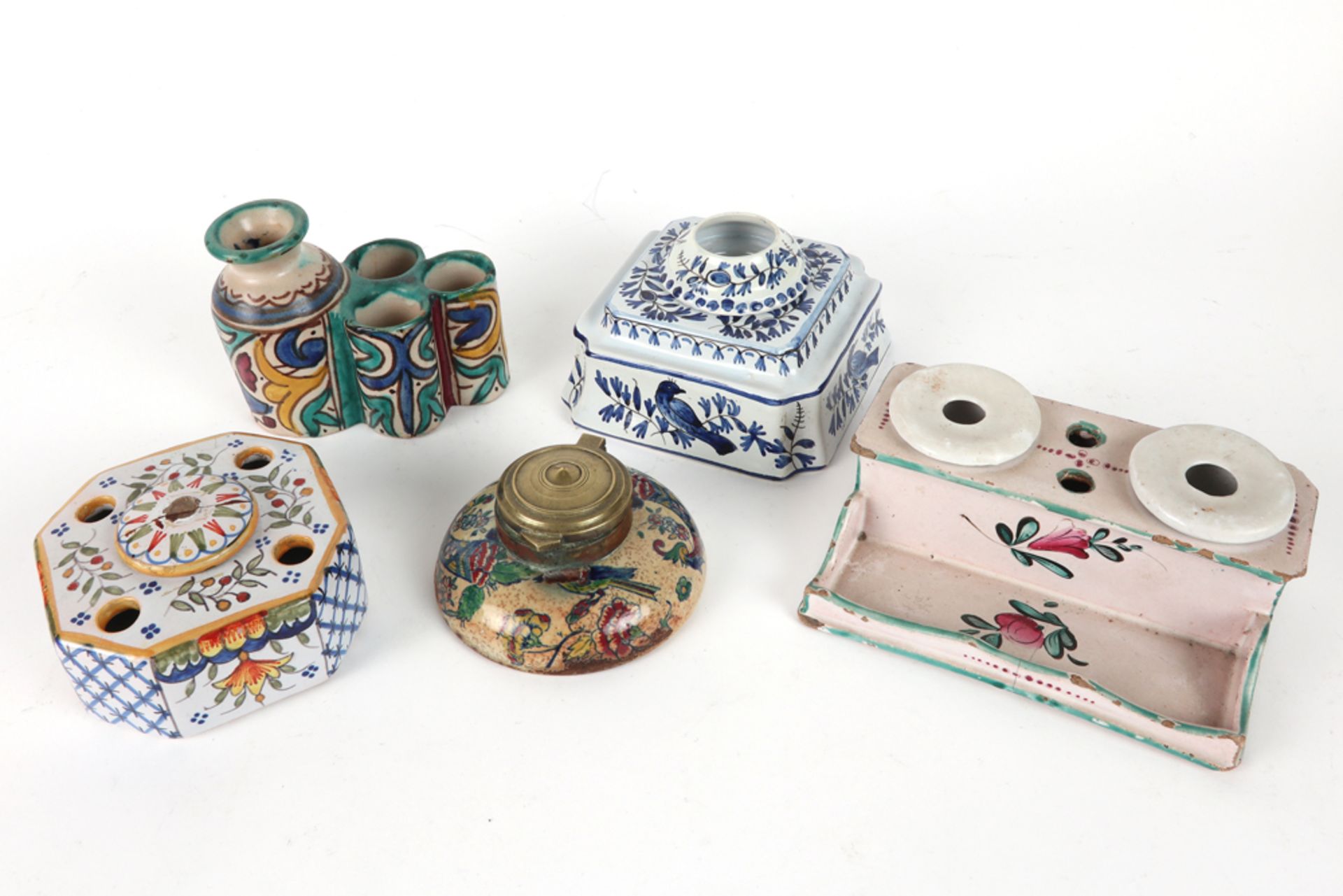 a Middle Eastern, ceramic inkwell and four antique French ceramic inkwells, each with a polychrome d