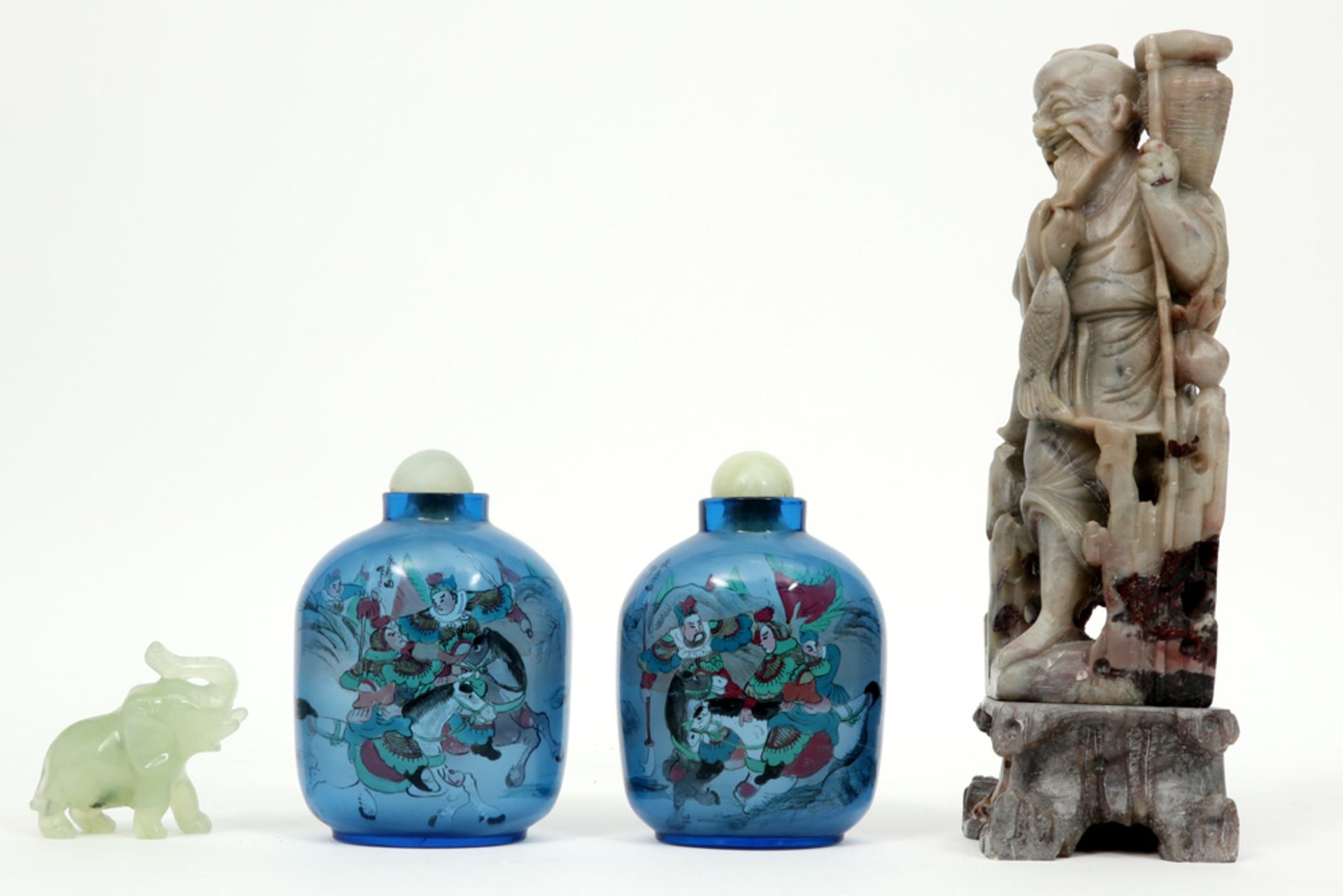 four Chinese items with two glass flasks, a soapstone figure and a jade elephant