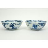 pair of antique Chinese bowls in marked porcelain with a blue-white decor with figures in a garden