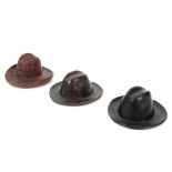 three 'antique' wooden inkwells shaped as a hat