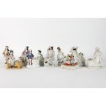 ten antique inkwells in porcelain, each with a figure