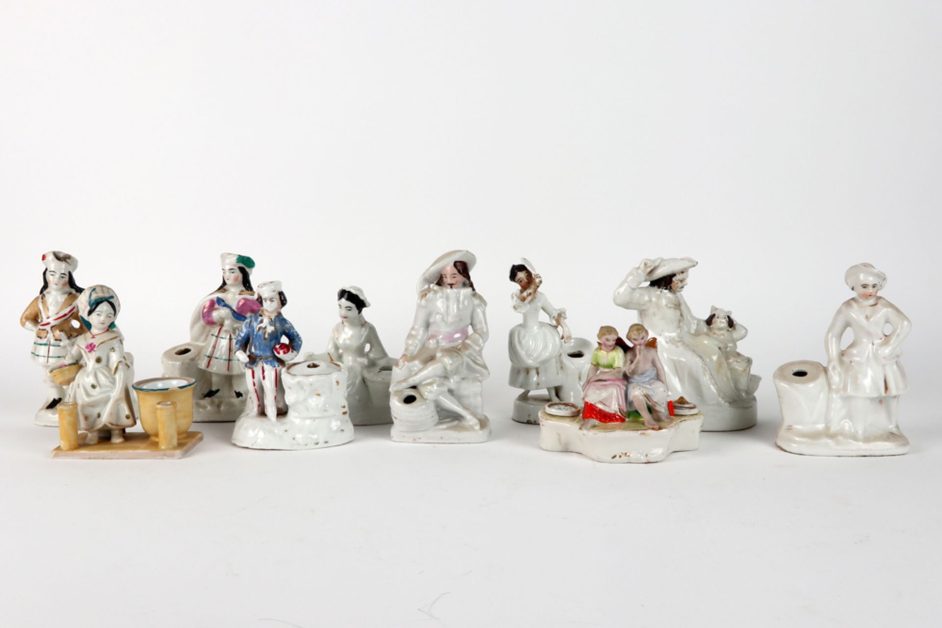 ten antique inkwells in porcelain, each with a figure