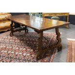 antique, because of its size less common Spanish table in walnut with typical legs and a characteris