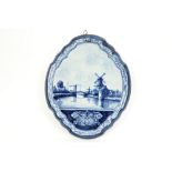 antique plaque in Dutch marked ceramic with a blue-white landscape decor